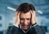Are You Burned Out? 8 Warning Signs to Watch For Stressed Person Hands Head