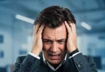 Are You Burned Out? 8 Warning Signs to Watch For Stressed Person Hands Head